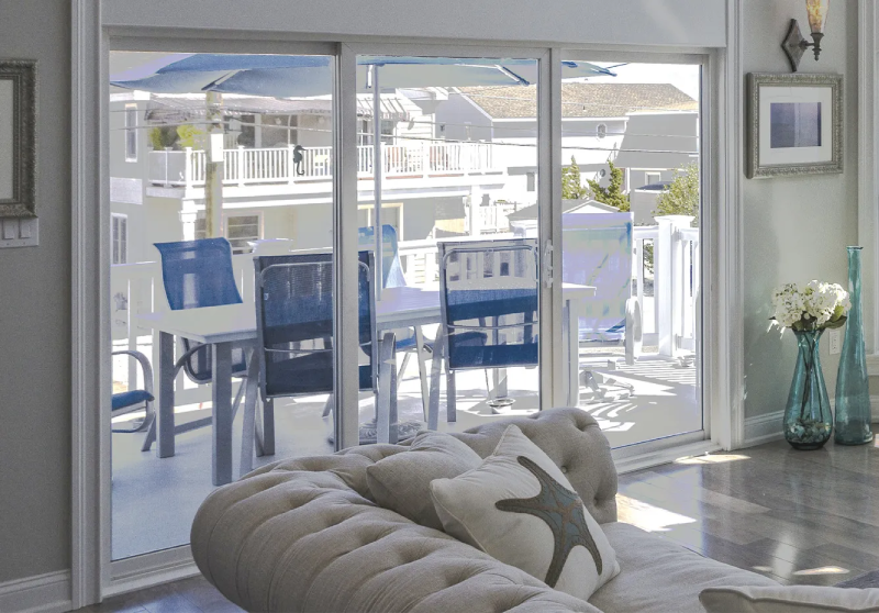 Technician from K-Boys Construction installs hurricane-rated impact windows on a home in Palm Beach County, Florida.