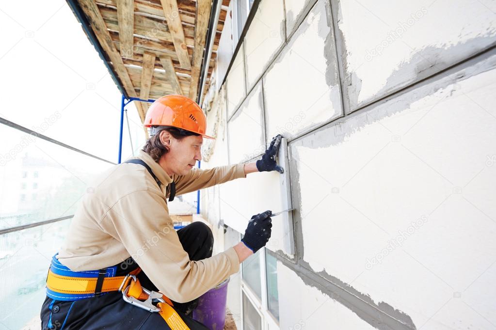 K-Boys Construction technician applying smooth stucco to a residential home in Palm Beach Gardens, Florida.