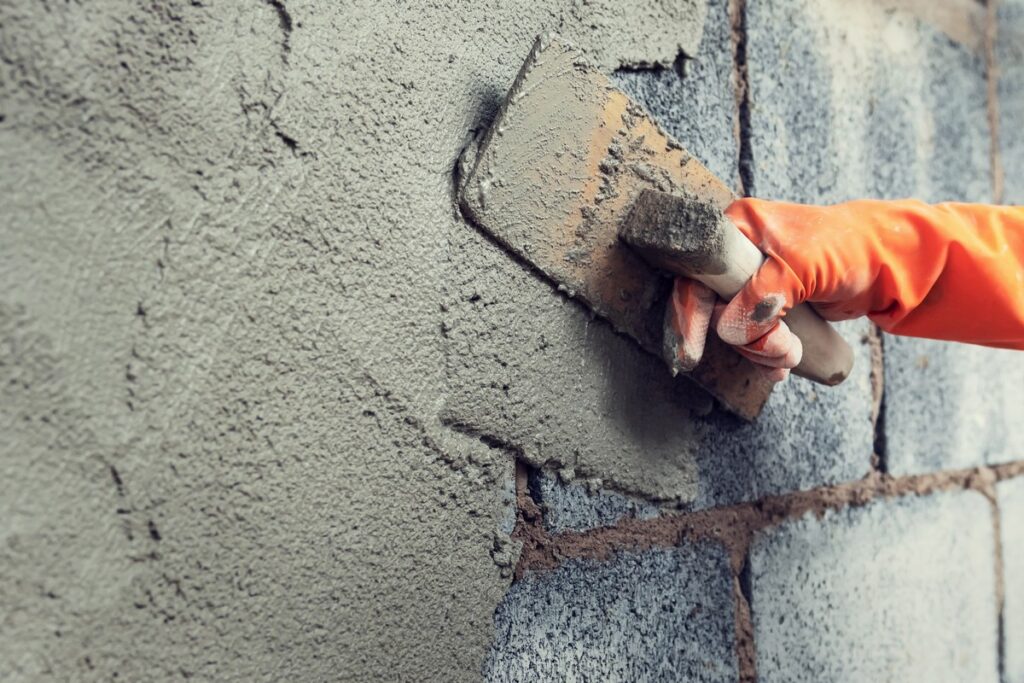 K-Boys Construction technician applies smooth stucco finish to a luxury home in Palm Beach Island, Florida.