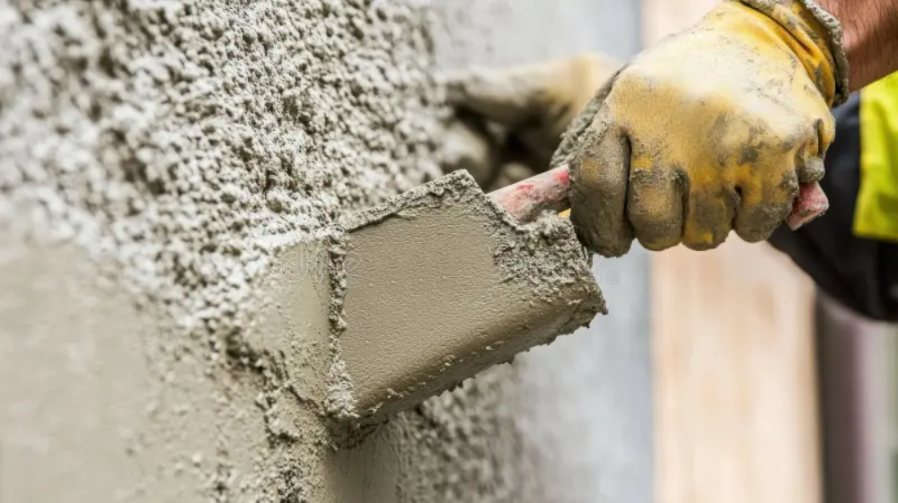 Stucco repair specialist fixing cracks on a residential exterior in Indiantown Florida